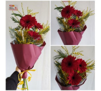 Bright red gerbera combined with spring mimosa!